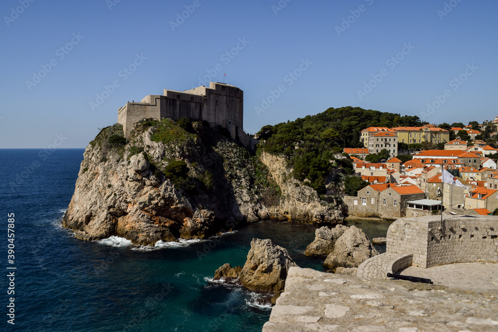 Rocks, Adriatic sea and Dubrovnik old city in a beautiful sunny day.