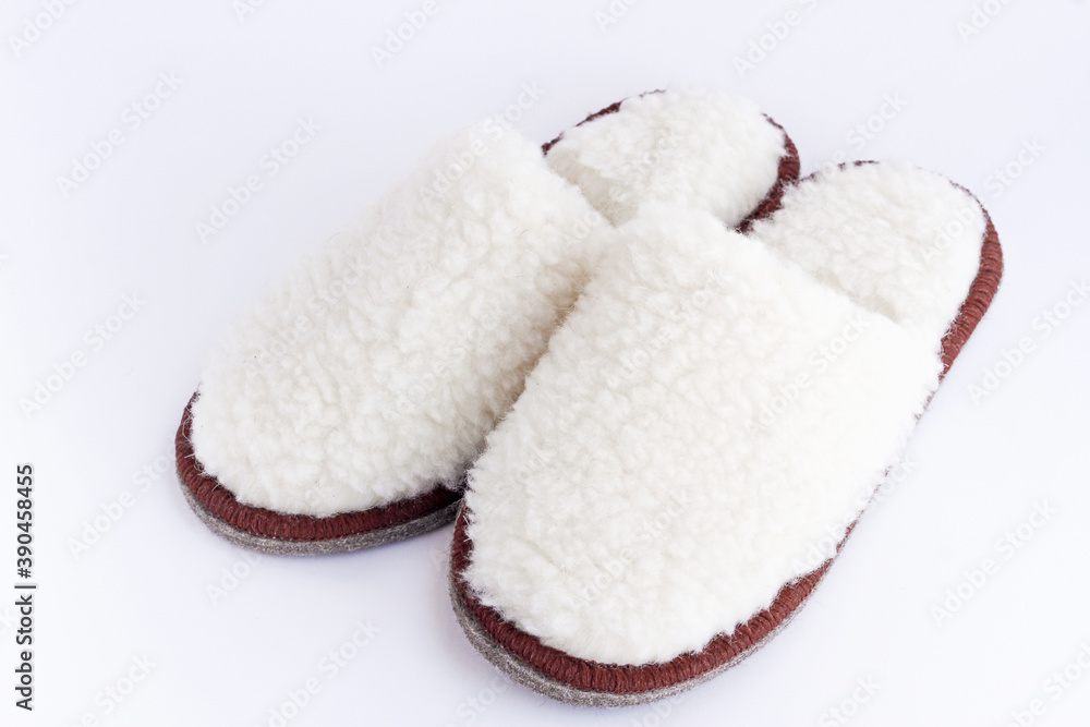 a pair of white home cozy Slippers made of wool on a white background