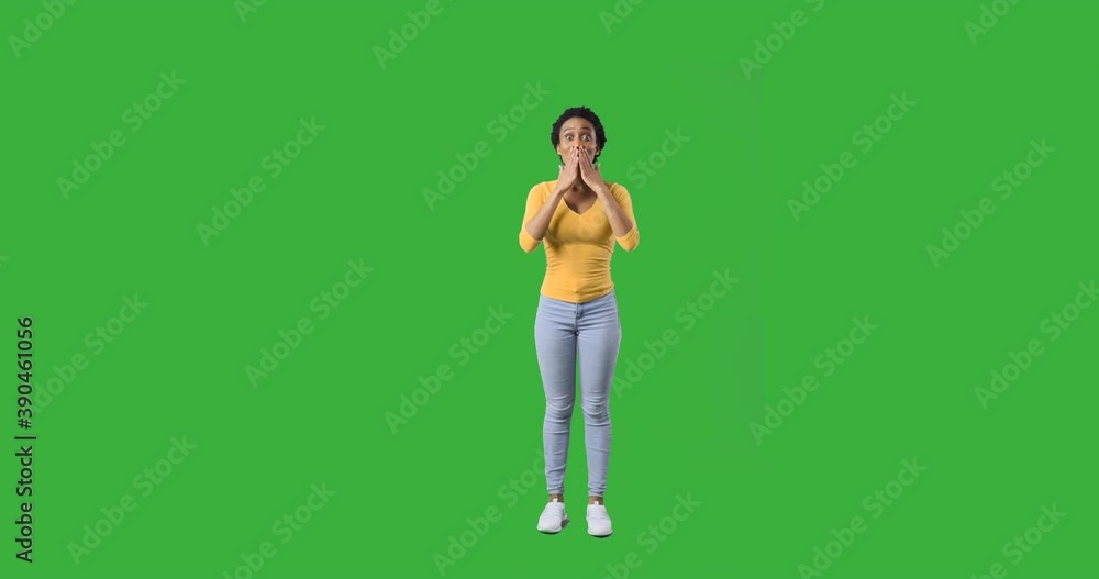 Ecstatic african american woman shouting and celebrating success over green background Ecstatic african american woman shouting and celebrating success over green background