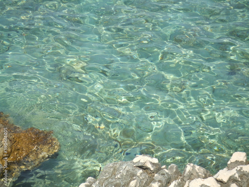 Patterns of sunlight reflected in clear turquoise water