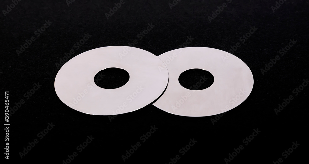 Two metal discs on a black background Two metal discs on a black background