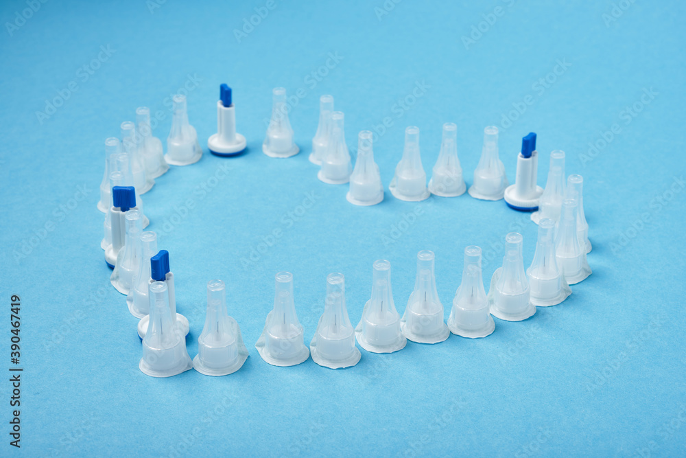 insulin needles in the form of a heart on a blue background insulin needles in the form of a heart on a blue background