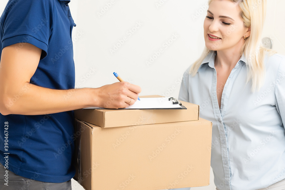 Woman sigining electronic receipt of delivered package Woman sigining electronic receipt of delivered package