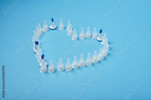 insulin needles in the form of a heart on a blue background