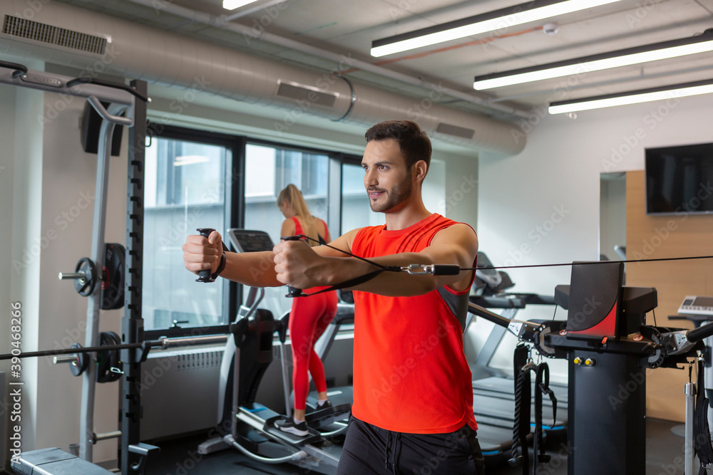 Handsome couple workout together in modern gym Handsome couple workout together in modern gym