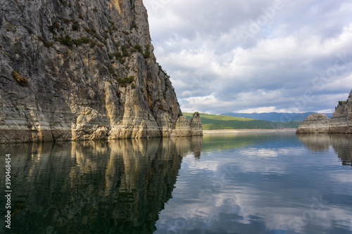  Reflection of rocks in water on a cloudy day