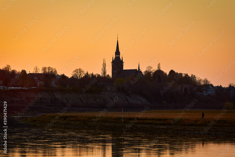 silhouette of a church in the city of Cossebaude near Dresden on the river Elbe at sunset in the evening light