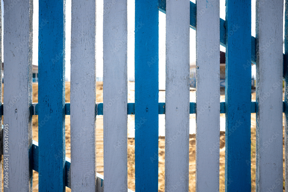 Wooden blue and white fence with beach background