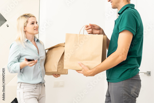 Woman sigining electronic receipt of delivered package © Angelov