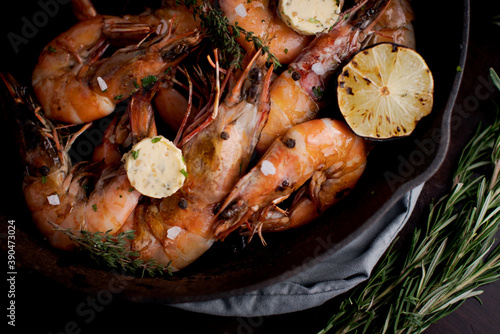 Jumbo shrimp grilled in skillet with rosemary and lemon
