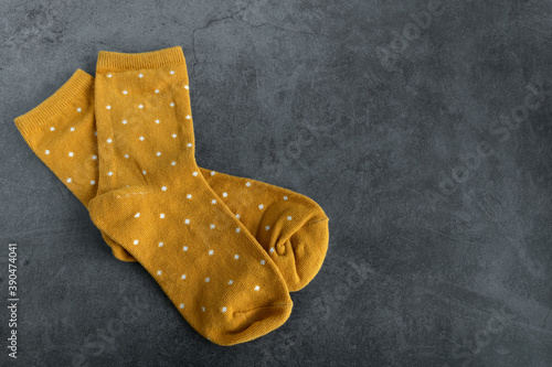 A pair of yellow socks on dark background