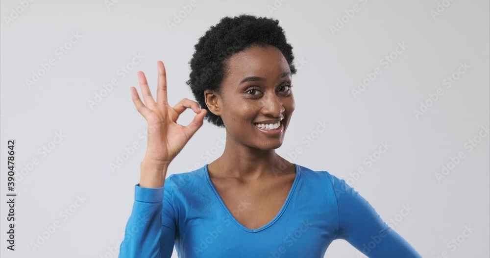 Happy african american woman showing ok hand sign Happy african american woman showing ok hand sign
