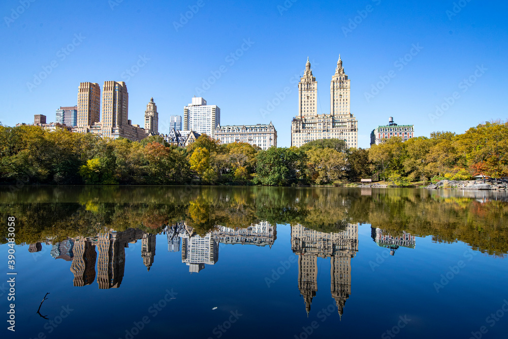 Trees and buildings reflect off the Lake in Central Park