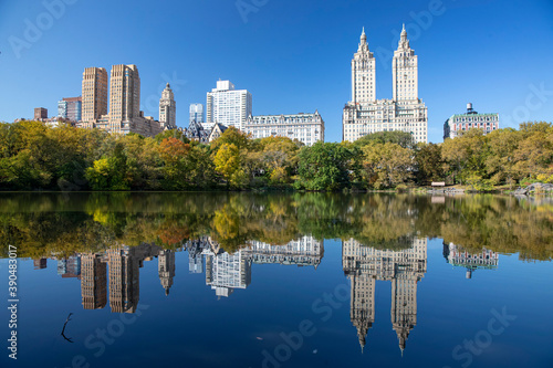 Trees and buildings reflect off the Lake in Central Park