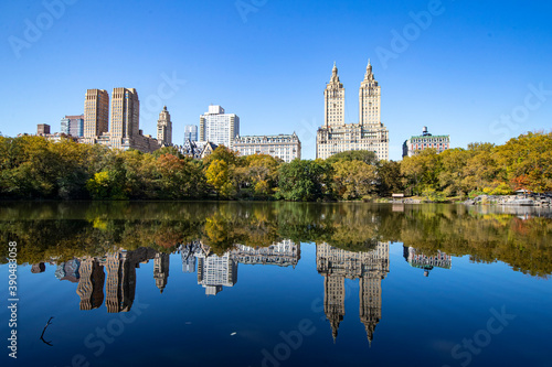 Trees and buildings reflect off the Lake in Central Park