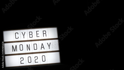 cyber monday word written on lightbox on black background. Flat lay, top view.
