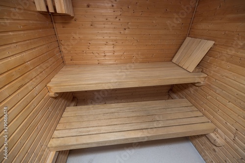 Close up view of sauna room interior. Wooden walls and seats. Health concept.