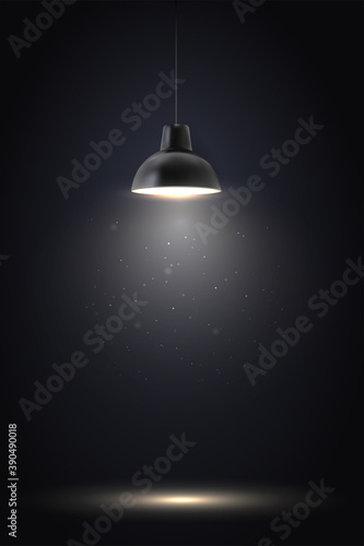 Lamp in dark room. Spotlight on black background. Place for text or product presentation.