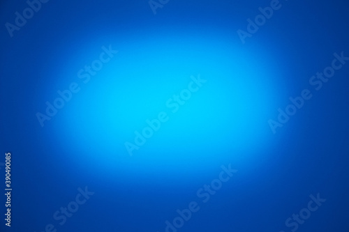 On a blue background, a light blue oval cloud of light