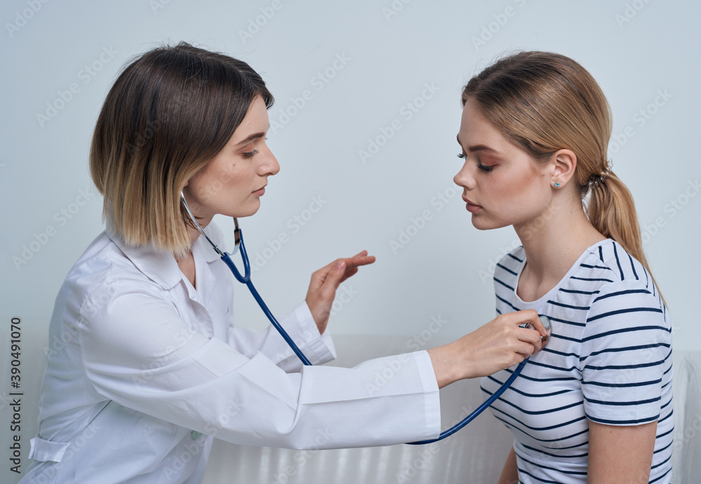 Woman doctor with stethoscope and patient at the reception Woman doctor with stethoscope and patient at the reception