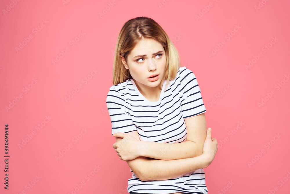 Woman in striped t-shirt emotions studio cropped view lifestyle pink isolated background Woman in striped t-shirt emotions studio cropped view lifestyle pink isolated background