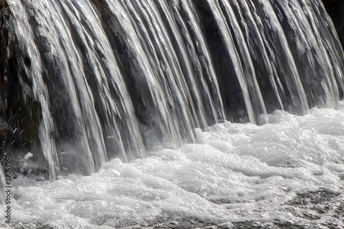 water cascading over rocks on a sunny day