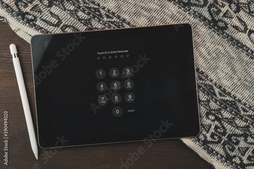 Digital Tablet and electronic pen on a wooden table. The template is empty. Workplace at home.