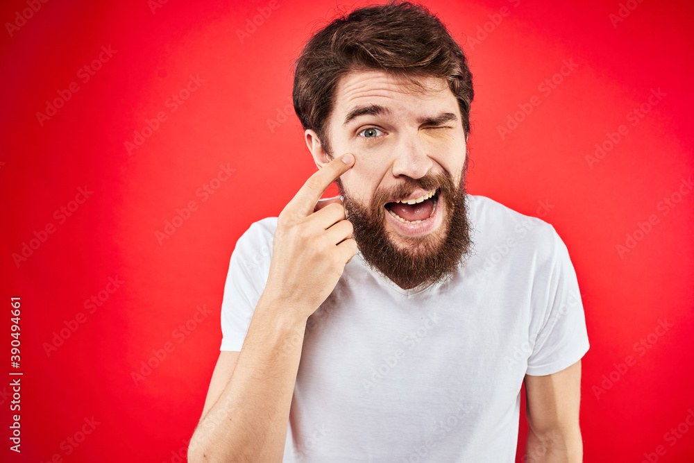 Bearded man fun emotions lifestyle cropped view white t-shirt red background Bearded man fun emotions lifestyle cropped view white t-shirt red background