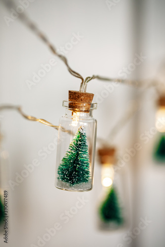 Christmas Tree Glass Jar Bottle String Lights with little Christmas trees inside bulbs © smiltena