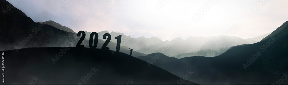 silhouette of number 2021 on mountain next to man celebrating, new year concept