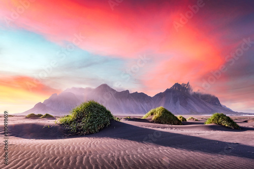 Gorgeous landscape with black sand desert dunes and grassy bumps near famous Stokksnes mountains on Vestrahorn cape, Iceland