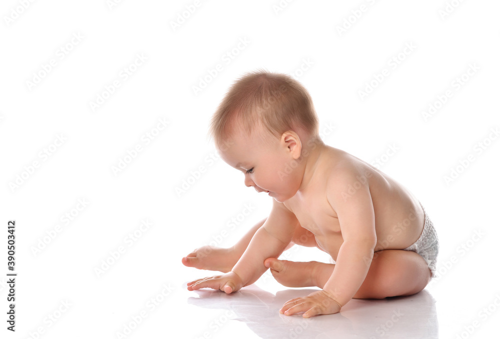 Adorable baby sitting and looking aside over white background Adorable baby sitting and looking aside over white background