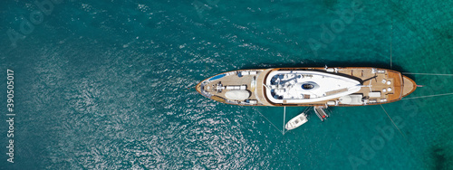 Aerial drone top down ultra wide photo of luxury yacht anchored in tropical exotic island turquoise sea
