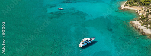 Aerial drone ultra wide panoramic view of tropical paradise sandy beach visited by sailboats and yachts in Caribbean exotic destination island © aerial-drone