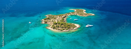 Aerial drone ultra wide photo of tropical exotic Caribbean island bay visited by luxury yachts and sailboats