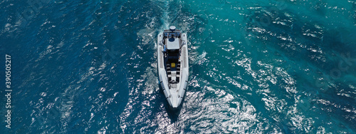 Aerial drone ultra wide photo of luxury inflatable speed boat cruising deep blue Aegean sea, Greece © aerial-drone