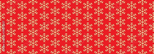 red background with gold snowflakes. Christmas background, festive banner. Pattern for festive wrapping paper.