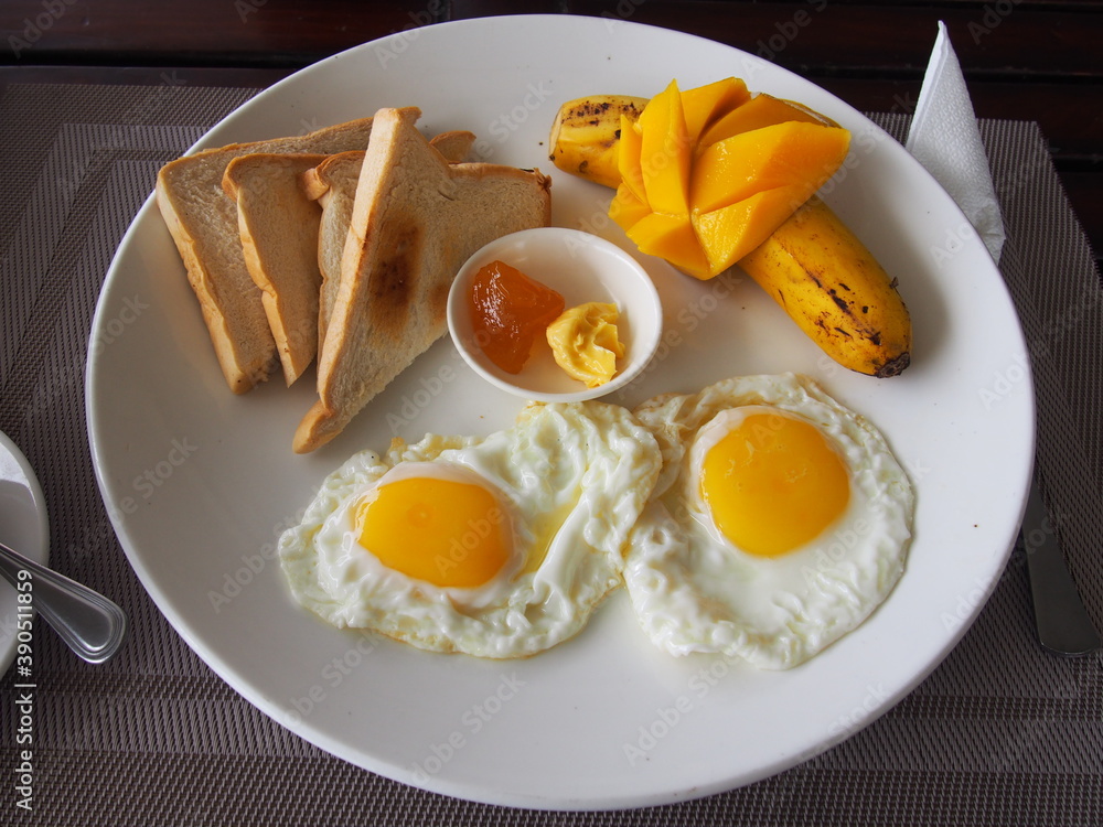 Fototapeta premium Breakfast set, Sunny-Side Up Fried Eggs, Sandwich, Mango, Banana, and Jam, Nalusuan Island, Cebu, Philippines