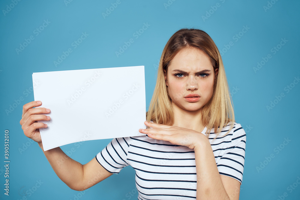 Woman holding sheet of paper striped T-shirt Copy Space cropped view blue background Woman holding sheet of paper striped T-shirt Copy Space cropped view blue background