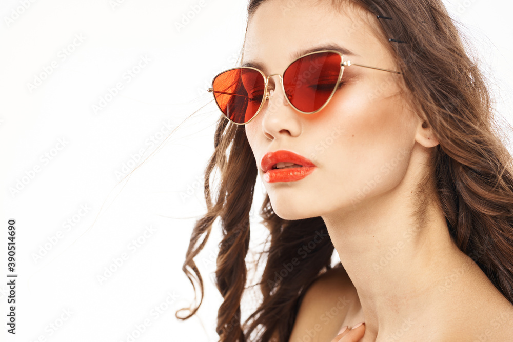 Portrait of brunette woman in sunglasses naked shoulders light background Portrait of brunette woman in sunglasses naked shoulders light background
