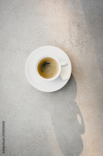 Dark Coffee in White Cup Espresso Morning Beverage Beautiful Shine Light and Shadow Marble Table Background Top View Flat Lay Minimalism