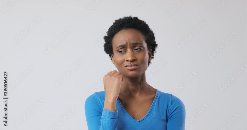 Worried african american woman regretting her mistake over white background Worried african american woman regretting her mistake over white background