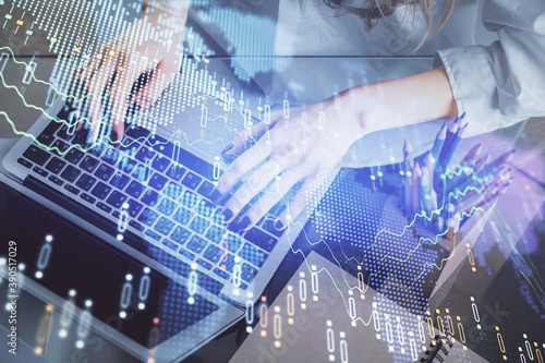 Double exposure of woman hands typing on computer and forex chart hologram drawing. Stock market invest concept.