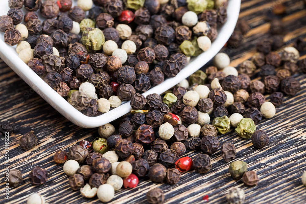 black peas pepper on an old wooden table black peas pepper on an old wooden table