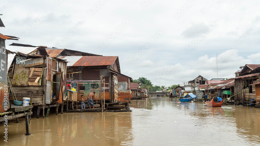 Wooden house on Karang Mumus Riverbank. Slum area on Karang Mumus river, Samarinda, Indonesia