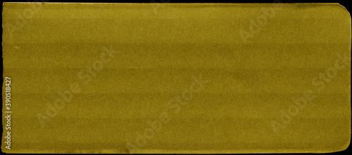 Close up of a yellow vintage torn sheet of carton. Cardboard paper texture with a blank background. Empty papercraft surface. Isolated shape and element. photo