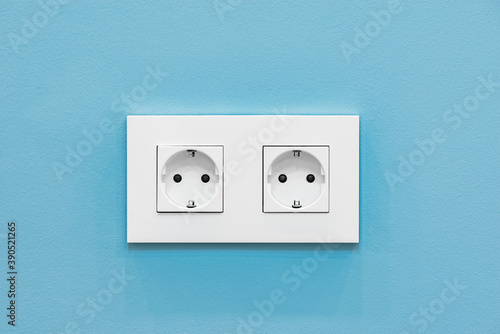 Power socket on blue wall background.