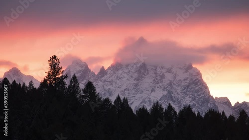 Grand Teton National Park Timelapes, Sunset with tree line and the Grand Teton.  photo
