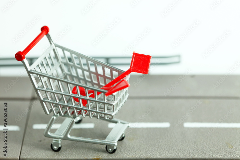 Miniature shopping cart model containing traffic signage pole model scene represent roadwork material online shopping concept related idea. Miniature shopping cart model containing traffic signage pole model scene represent roadwork material online shopping concept related idea.