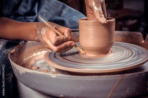 Craftsman master sculptor works with clay on a Potter's wheel and at the table with the tools. Inspiration and creativity. Close-up.